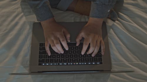 Man Typing on His Laptop