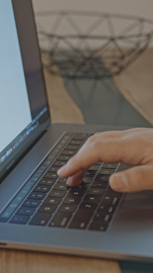 A Man Eating While Working On His Laptop