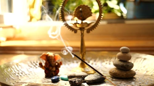 Burning Incense Stick in a Small Altar