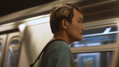 Man Standing In front of a Moving Metro Train