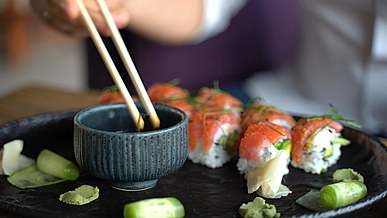 man eating sushi