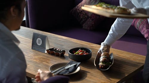 Waiter Serving Meal to the Customer