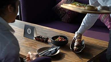 waiter serving meal to the customer