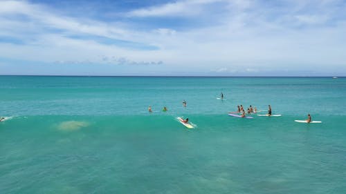 Surfers Surfing in the Ocean