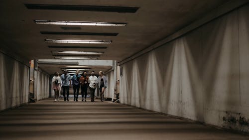 Group of People Walking on the Tunnel