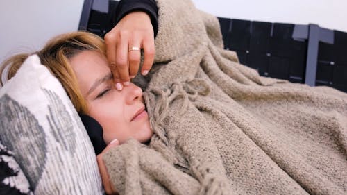 Woman Suffering from Flu Lying on a Sofa