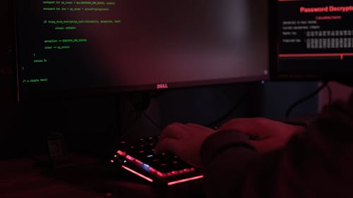 A Hacker Typing on a Keyboard