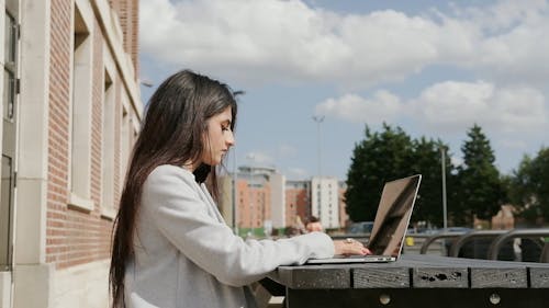 Side View of a Woman Using Laptop