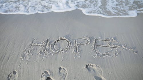 The Word Hope Written on the Shore at a Beach