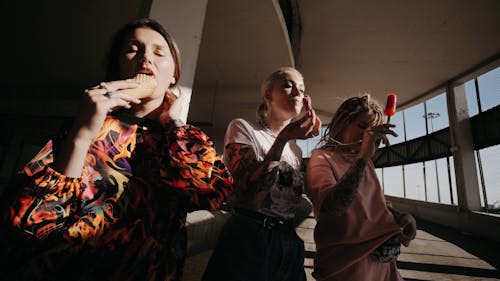 Women Eating an Ice Cream and Popsicles