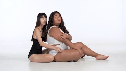 A Slim Model Sits Behind A Curvy Model and Pose