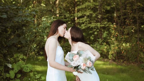 Woman Kissing while Holding the Bouquet