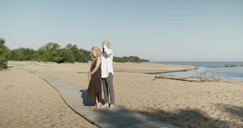 A Couple Standing on a Wooden Walkway