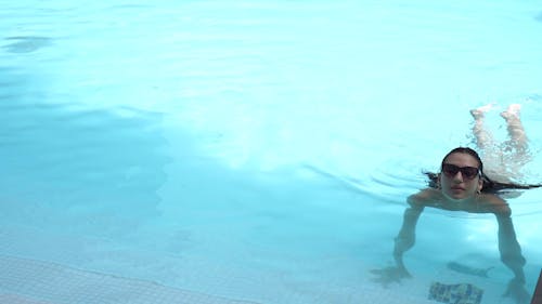 Young Woman Coming out of a Swimming Pool