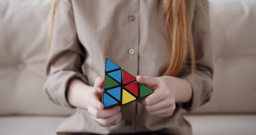 Woman Solving a Pyraminx Puzzle