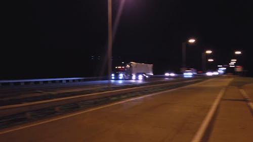 Car Over Taking a Transport Truck on Expressway