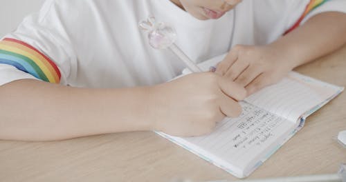 Girl Doing Her Math Work in Notebook