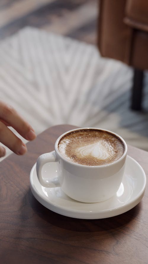 A Person Taking a Cup of Coffee