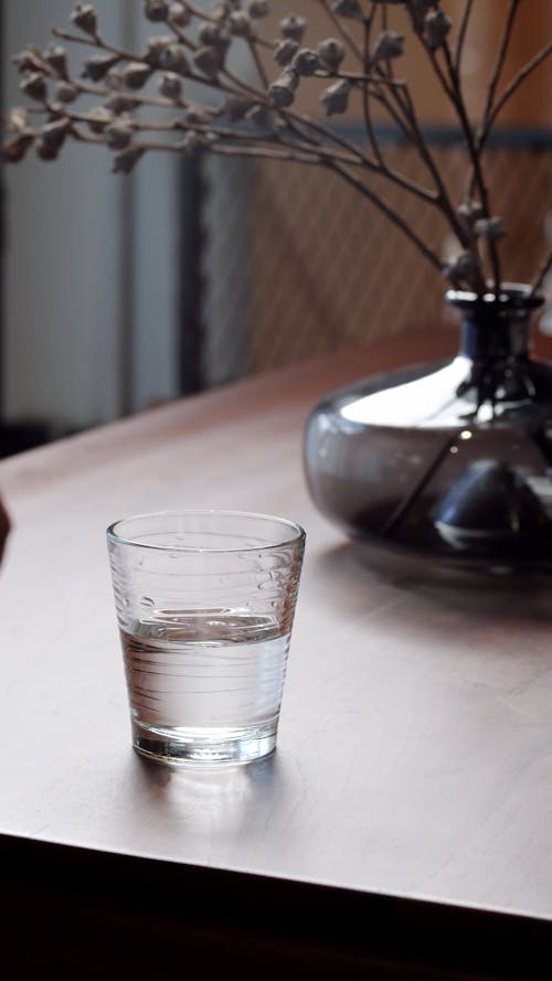 A Glass of Water on a Wooden Table