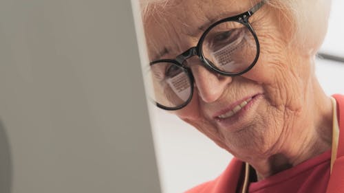 Close-Up View of a Woman Wearing Eyeglasses While Smiling