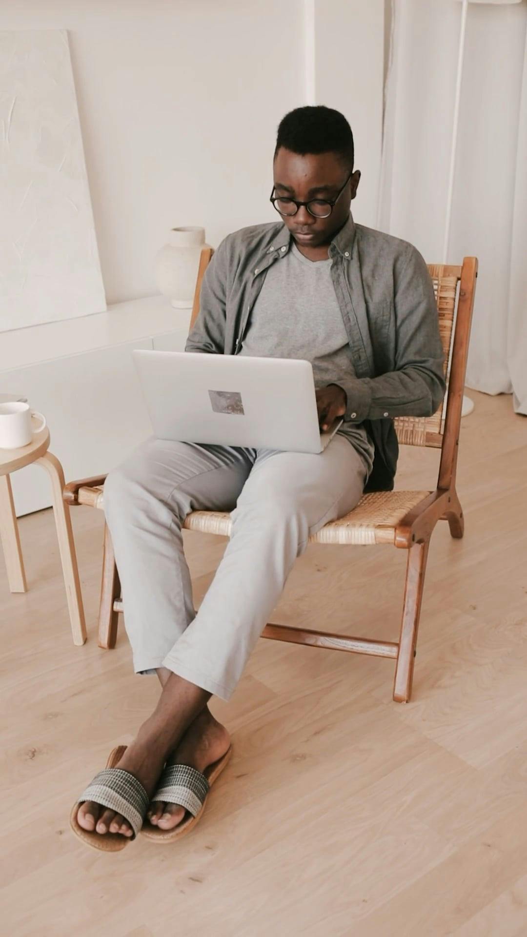 A Man Sitting on a Couch while Using His Laptop and Mobile Phone · Free Stock Video