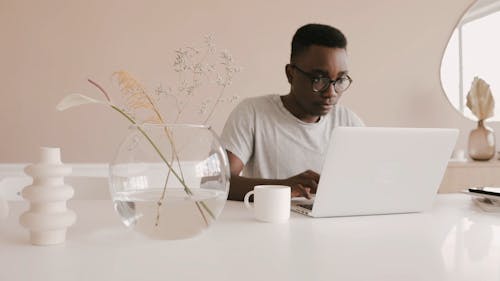 Man Busy Working on his Laptop at Desk