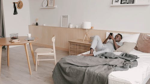 Man Working Inside His Bedroom