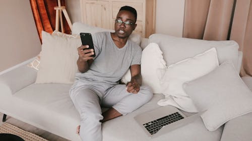 A Man Having a Video Call while Using His Laptop