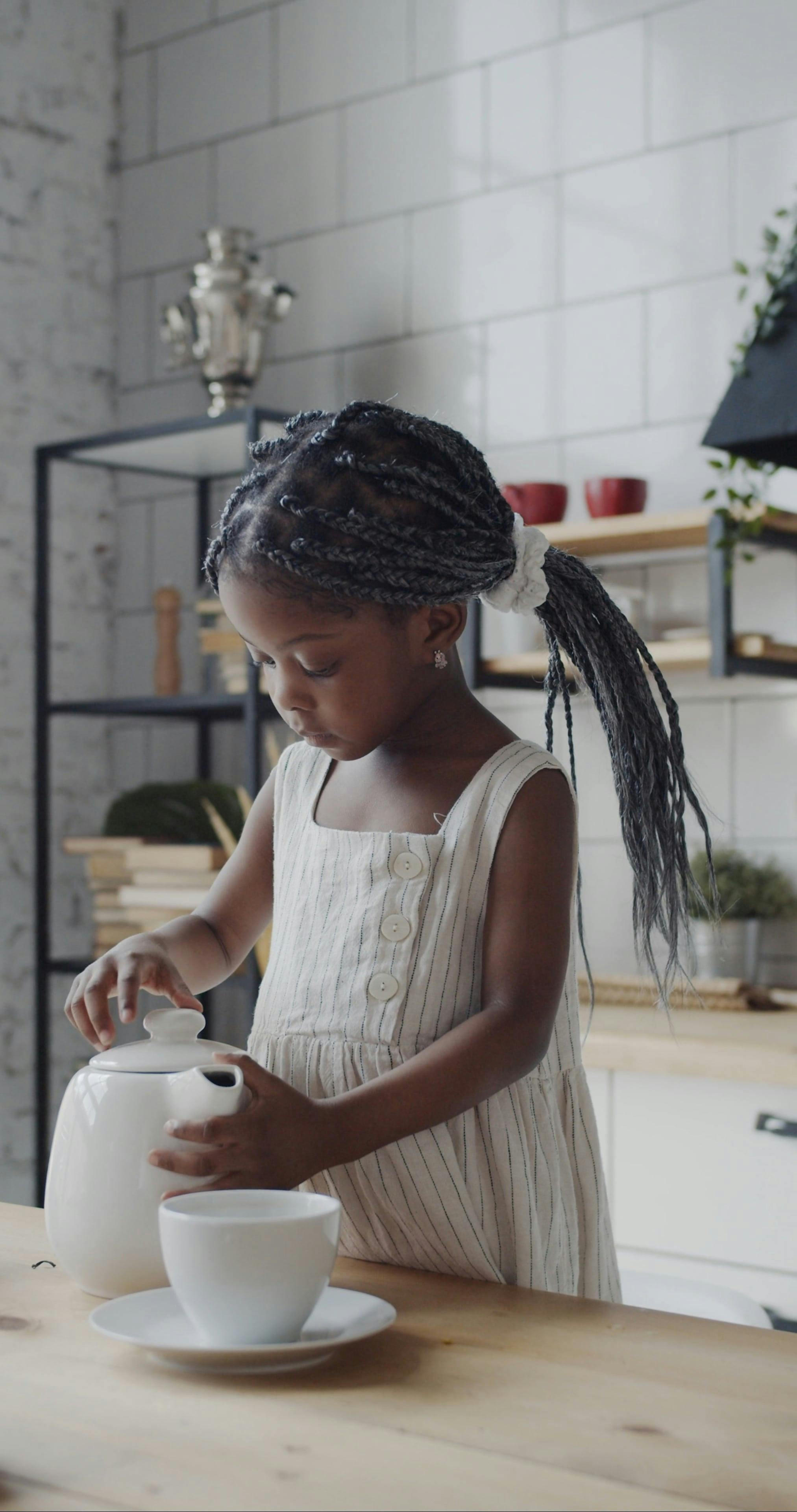 A Cute Little Girl Pouring Water into a Cup · Free Stock Video