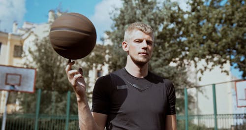 Man Spinning the Basketball on His Index Finger