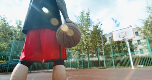 A Basketball Man Doing a Layup Shot