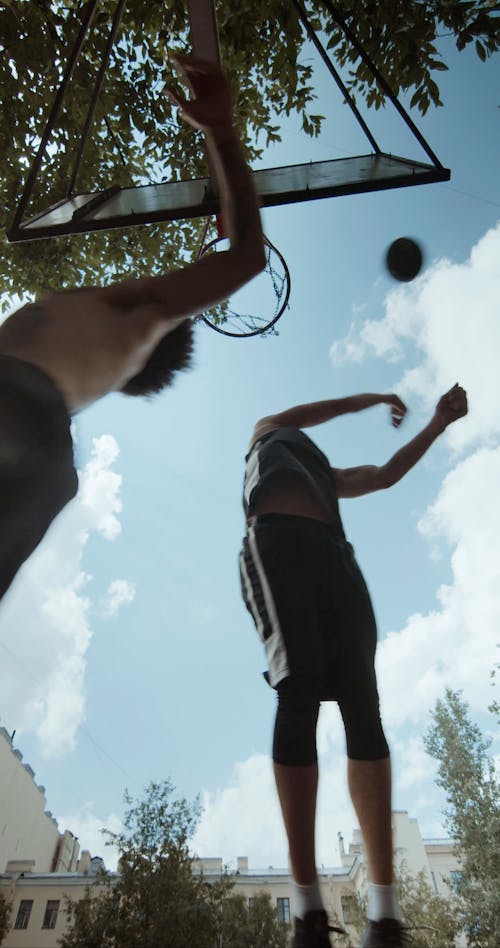 Guy Blocks Other Person from Scoring in Basketball Game