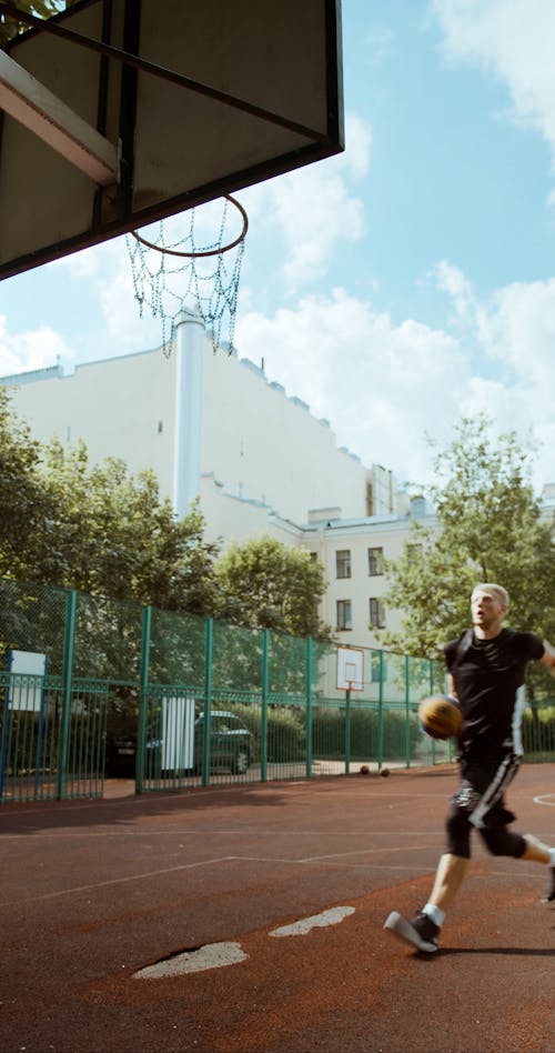 A Man Dunking a Basketball