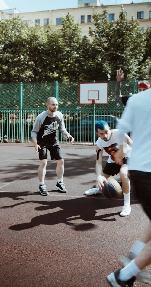 Four Men Playing Basketball