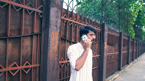 A Man Talking on the Phone Outside