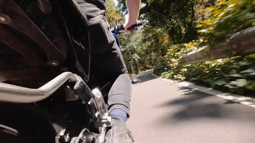 Side View of a Biker Riding Fast on Highway