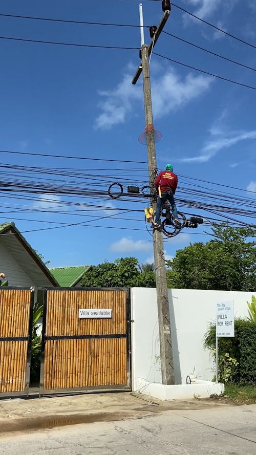 Men Up In The Electric Post Fixing The Lines