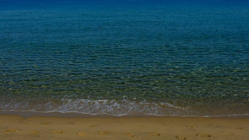 Crashing Waves on the Beach Sand