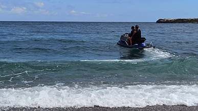people riding jet skis