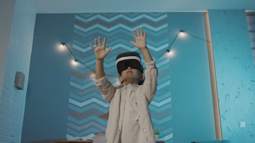 Curious Boy with VR Headset Moving Hands Around