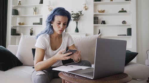 A Woman With Blue Hair Remote Working At Home