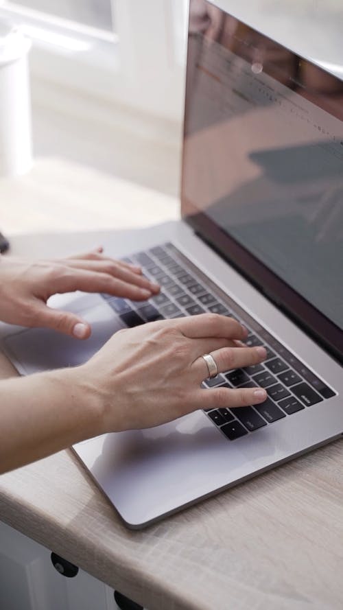 A Person Typing on a Laptop