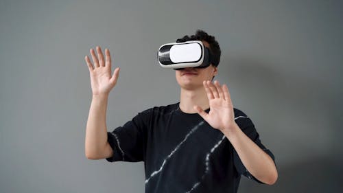 Man Playing a Game on a Virtual Reality Console