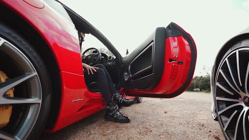 A Woman Going Inside Her Ferrari