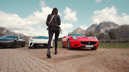 Woman Walking Towards a Luxury Sports Car