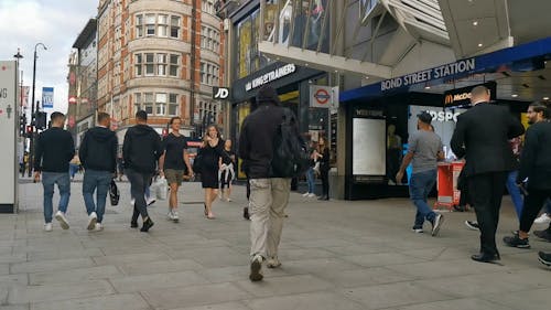 People Walking by Bond Street Station Entry Gate