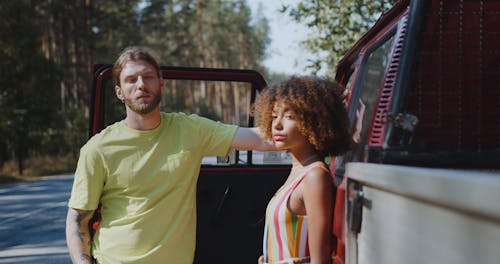 Young Couple Standing on Road Next to Pick up Truck