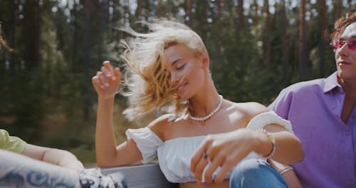 Young Woman Looking at Camera Fixing her Hair