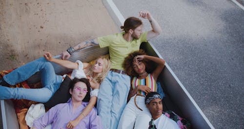A Group of Friends on a Road Trip Lying at Back of Pickup Truck