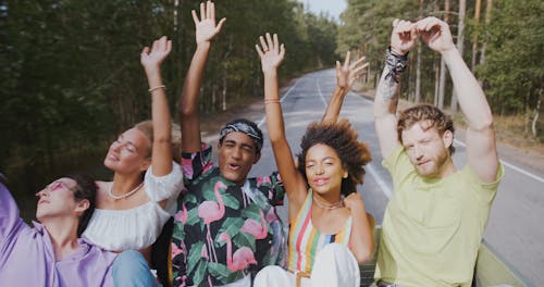 Group of Young People Travelling in Back of Pickup Truck